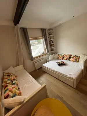 a small bedroom with a bed and a window at Apartman Brvenik 103, Konaci, Kopaonik in Kopaonik
