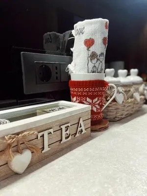 a table with cups and a tea box on a counter at Teddy Apartman Kula Konaci in Kopaonik
