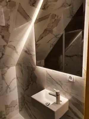 a bathroom with a white sink and a mirror at VT apartman-KOZNIK in Kopaonik