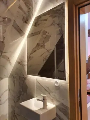 a bathroom with a sink and a mirror at VT apartman-KOZNIK in Kopaonik