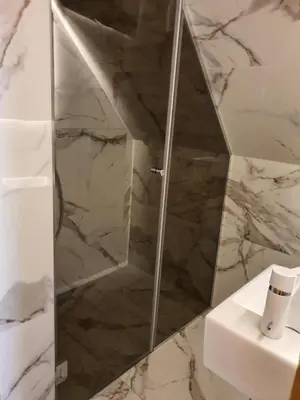a shower with a glass door in a bathroom at VT apartman-KOZNIK in Kopaonik