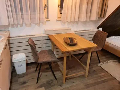 a table and two chairs in a small room at VT apartman-KOZNIK in Kopaonik