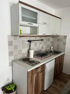a small kitchen with a sink and a microwave at Sunčani breg in Kopaonik