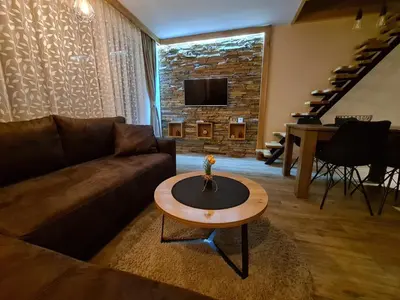 a living room with a couch and a table at Starloft Kopaonik in Kopaonik