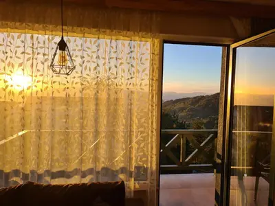 a living room with a curtain and a window at Starloft Kopaonik in Kopaonik