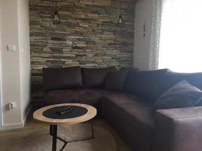 a living room with a couch and a table at Starloft Kopaonik in Kopaonik