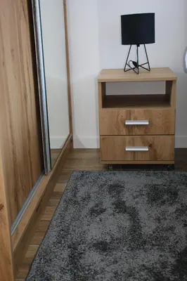 a room with a wooden dresser with a television on it at Starloft Kopaonik in Kopaonik