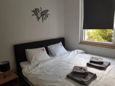 a bed with towels on top of it with a window at Starloft Kopaonik in Kopaonik