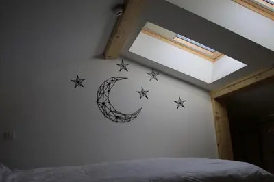 a bedroom with a c and stars on the wall at Starloft Kopaonik in Kopaonik