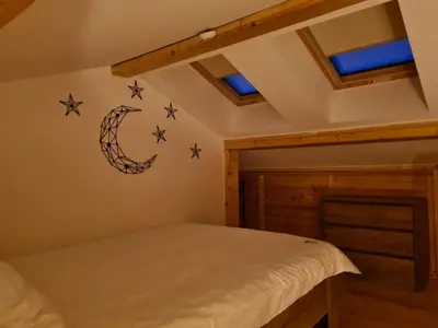 a bedroom with a bed and stars on the wall at Starloft Kopaonik in Kopaonik