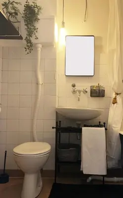 a bathroom with a toilet and a sink at Alva Apartment in Niš