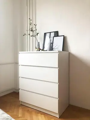 a white chest of draws in a bedroom at Alva Apartment in Niš