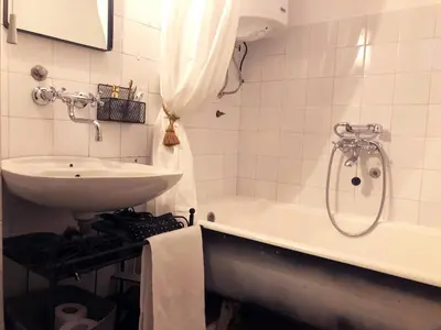 a bathroom with a sink and a tub next to a sink at Alva Apartment in Niš