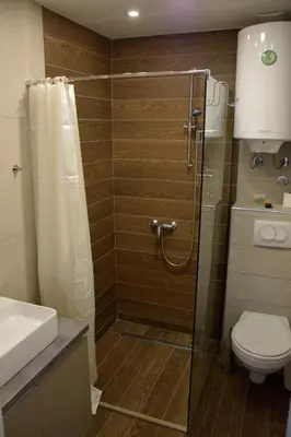 a bathroom with a shower with a toilet and a sink at DA-MA Milmari in Kopaonik