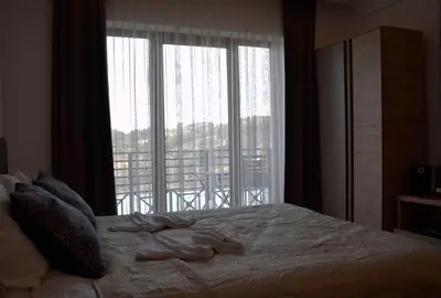 a bedroom with a bed with a large window at DA-MA Milmari in Kopaonik