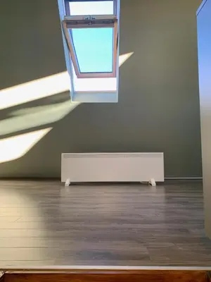 an empty room with a window and a radiator at G&D Apartment Kopaonik in Kopaonik