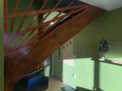 a living room with a wooden ceiling with beams at G&D Apartment Kopaonik in Kopaonik