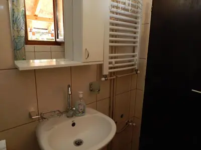 a bathroom with a sink and a mirror at Apartmani Jelica FREE PARKING in Vranje