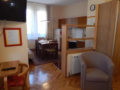 a living room with a kitchen and a dining room at Apartmani Jelica FREE PARKING in Vranje