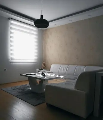 a living room with a white couch and a table at Apartman Teodora in Kopaonik