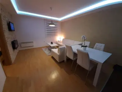 a living room with a white table and chairs at Apartman Teodora in Kopaonik