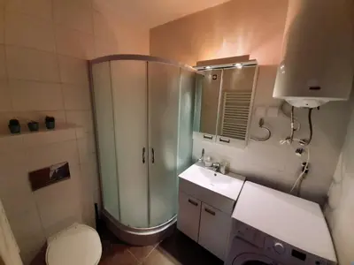 a bathroom with a shower and a toilet and a sink at Apartman Teodora in Kopaonik