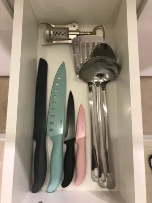 a drawer filled with knives and other kitchen utensils at FamilyKop Apartments Milmari in Kopaonik