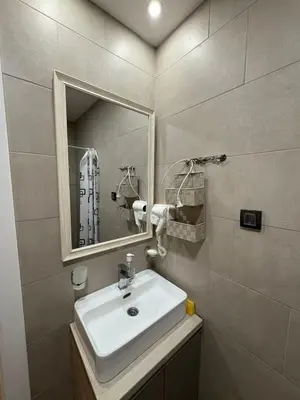 a bathroom with a sink and a mirror at Milmari apartman SAN-28 in Kopaonik