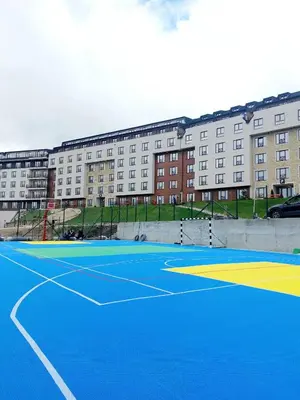 a tennis court in front of a building at Milmari apartman SAN-28 in Kopaonik