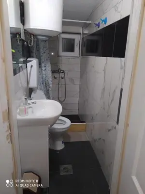 a small bathroom with a sink and a toilet at Apartmani Marić in Vrnjacka Banja in Vrnjačka Banja