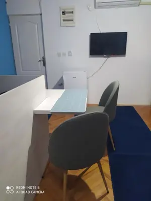 a table and a chair with a laptop on it at Apartmani Marić in Vrnjacka Banja in Vrnjačka Banja