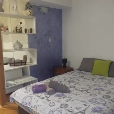 a bedroom with a bed with a teddy bear on it at Apartmani Marić in Vrnjacka Banja in Vrnjačka Banja