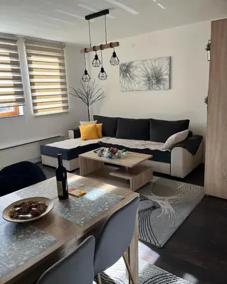 a living room with a couch and a table at Sunčani Breg apartman 10 in Kopaonik