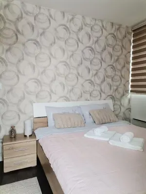 a bedroom with a bed with two pillows on it at Sunčani Breg apartman 10 in Kopaonik