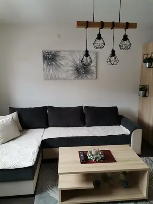 a living room with a couch and a coffee table at Sunčani Breg apartman 10 in Kopaonik