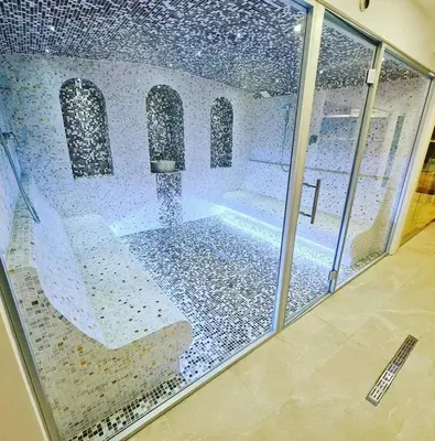 a view of a swimming pool through a glass window at Sunčani Breg apartman 10 in Kopaonik