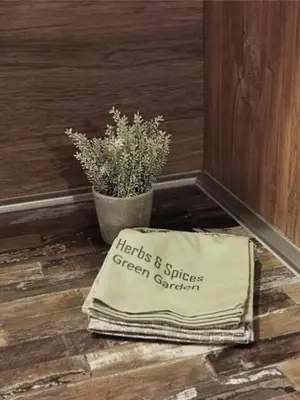 a pillow sitting on the floor next to a plant at S 68, Milmari Resort in Kopaonik