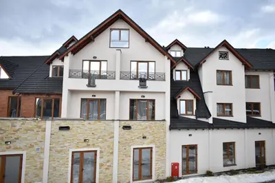 a large white house with black roof at S 68, Milmari Resort in Kopaonik