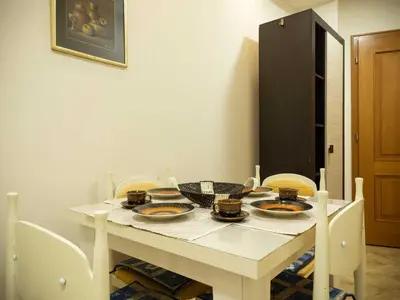 a white table with chairs and plates on it at Apartman Markos in Vrnjačka Banja