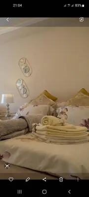 a bed with a bunch of towels on it at Apartman Markos in Vrnjačka Banja