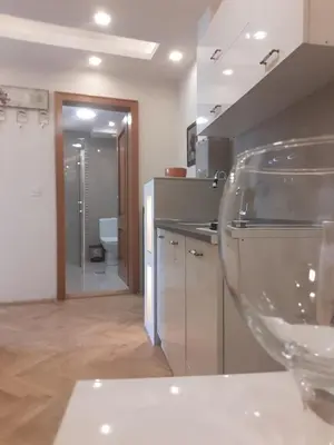 a wine glass sitting on a table in a kitchen at Apartman Markos in Vrnjačka Banja