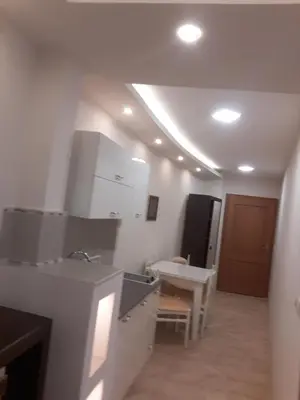 a kitchen with a sink and a table in a room at Apartman Markos in Vrnjačka Banja