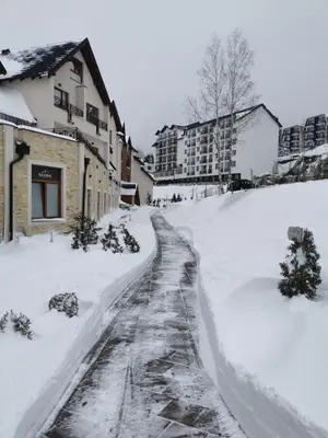 a snow covered street in a city with buildings at Apartment Mali Princ S18 Milmari resort in Kopaonik