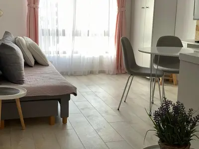 a room with a bed and a table and a table and chairs at Apartment Mali Princ S18 Milmari resort in Kopaonik