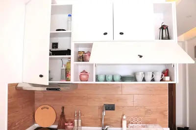 a kitchen with white cabinets and a sink at Apartment Mali Princ S18 Milmari resort in Kopaonik