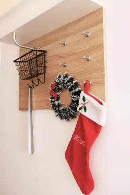 a christmas stocking and a wreath on a wall at Apartment Mali Princ S18 Milmari resort in Kopaonik