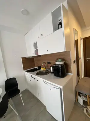 a small kitchen with white cabinets and a sink at Apartment Mali Princ S18 Milmari resort in Kopaonik