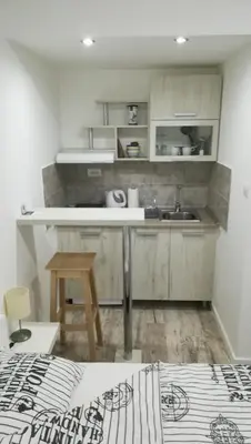 a kitchen with a sink and a counter top at M4U Apartments in Niš