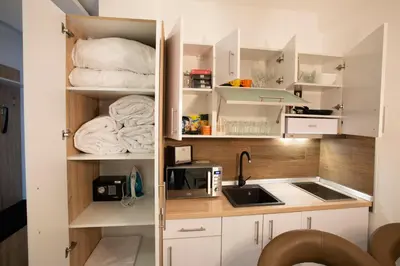 a small kitchen with white cabinets and a sink at Dream Lux Apartman Kopaonik in Kopaonik
