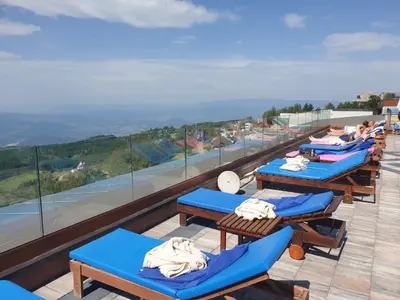 a row of lounge chairs on top of a roof at Dream Lux Apartman Kopaonik in Kopaonik
